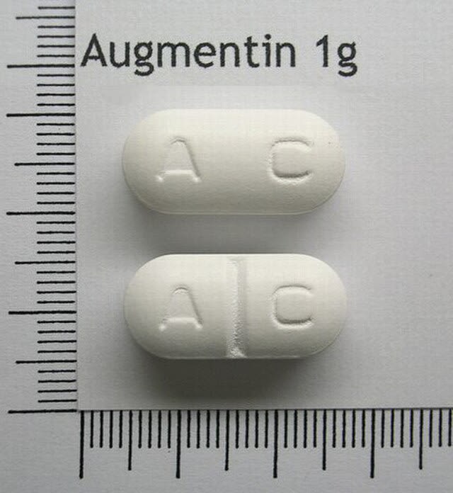 Two tablets of Augmentin placed on a piece of paper